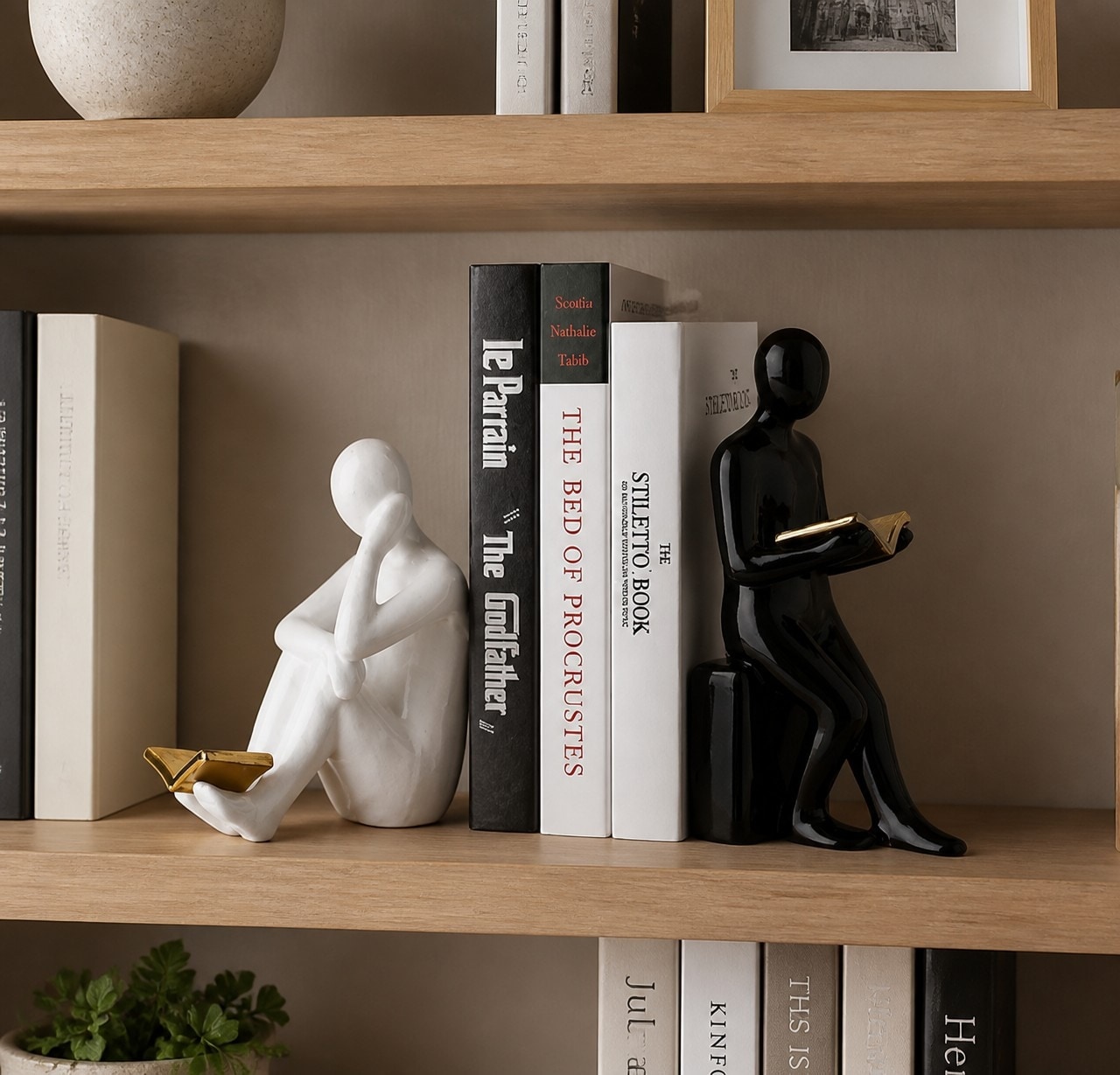 Black and white reading figure bookends styled on a wood bookshelf