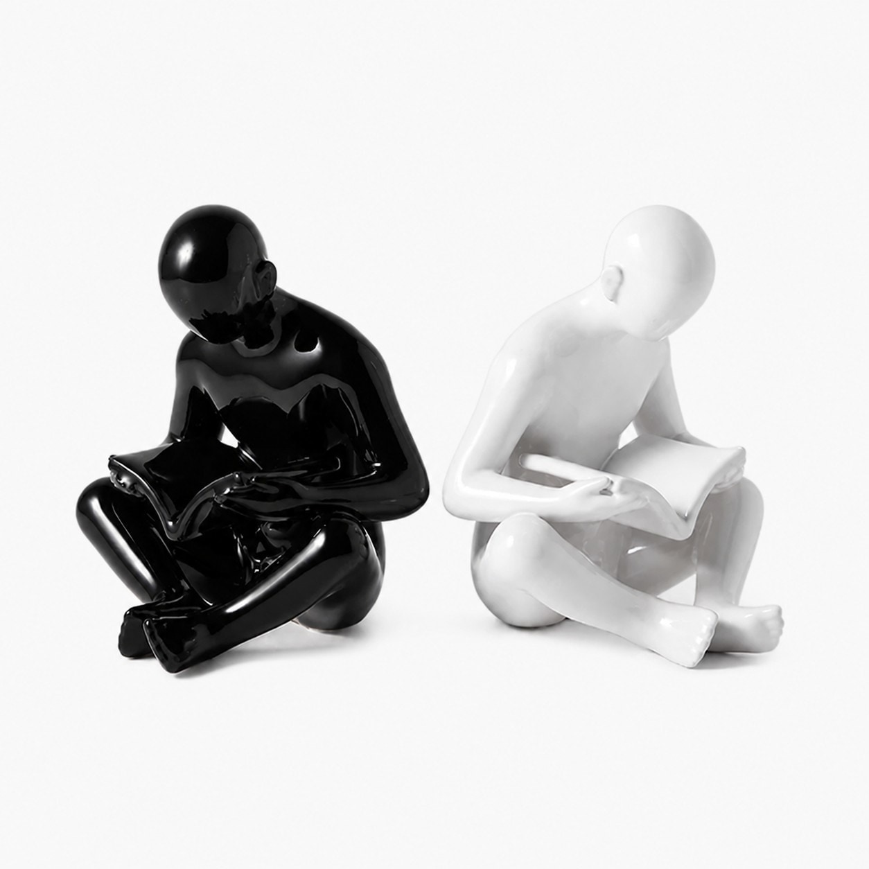 Black and white sitting reading figure ceramic bookends