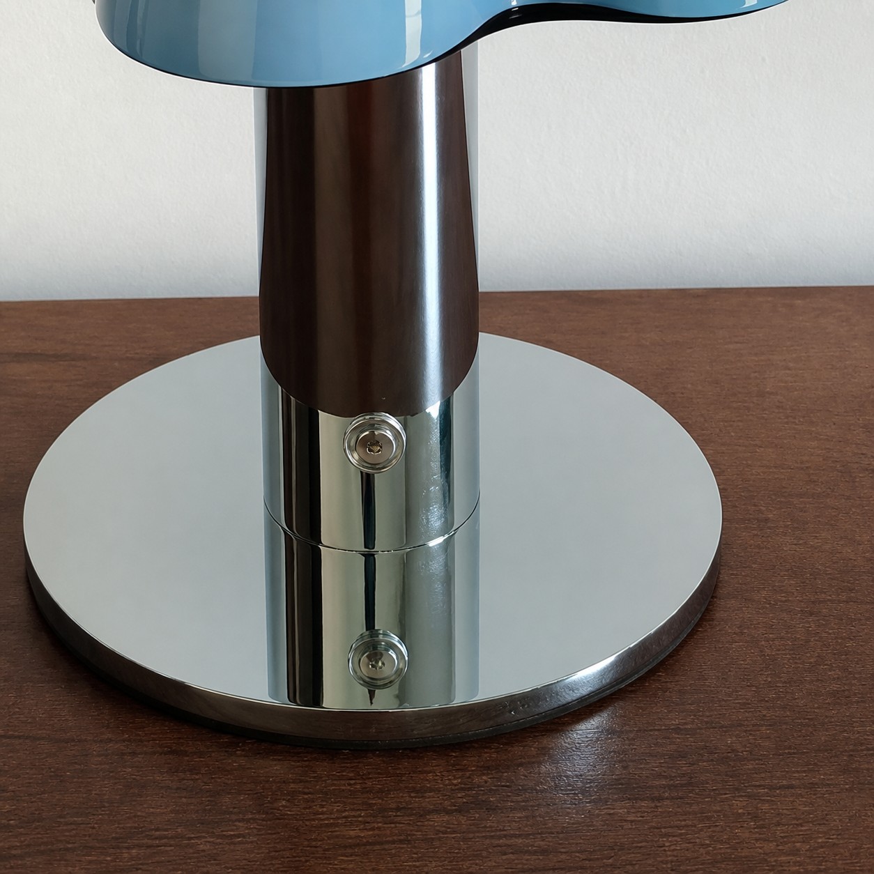 Close view of the chrome metal base, column, and button switch