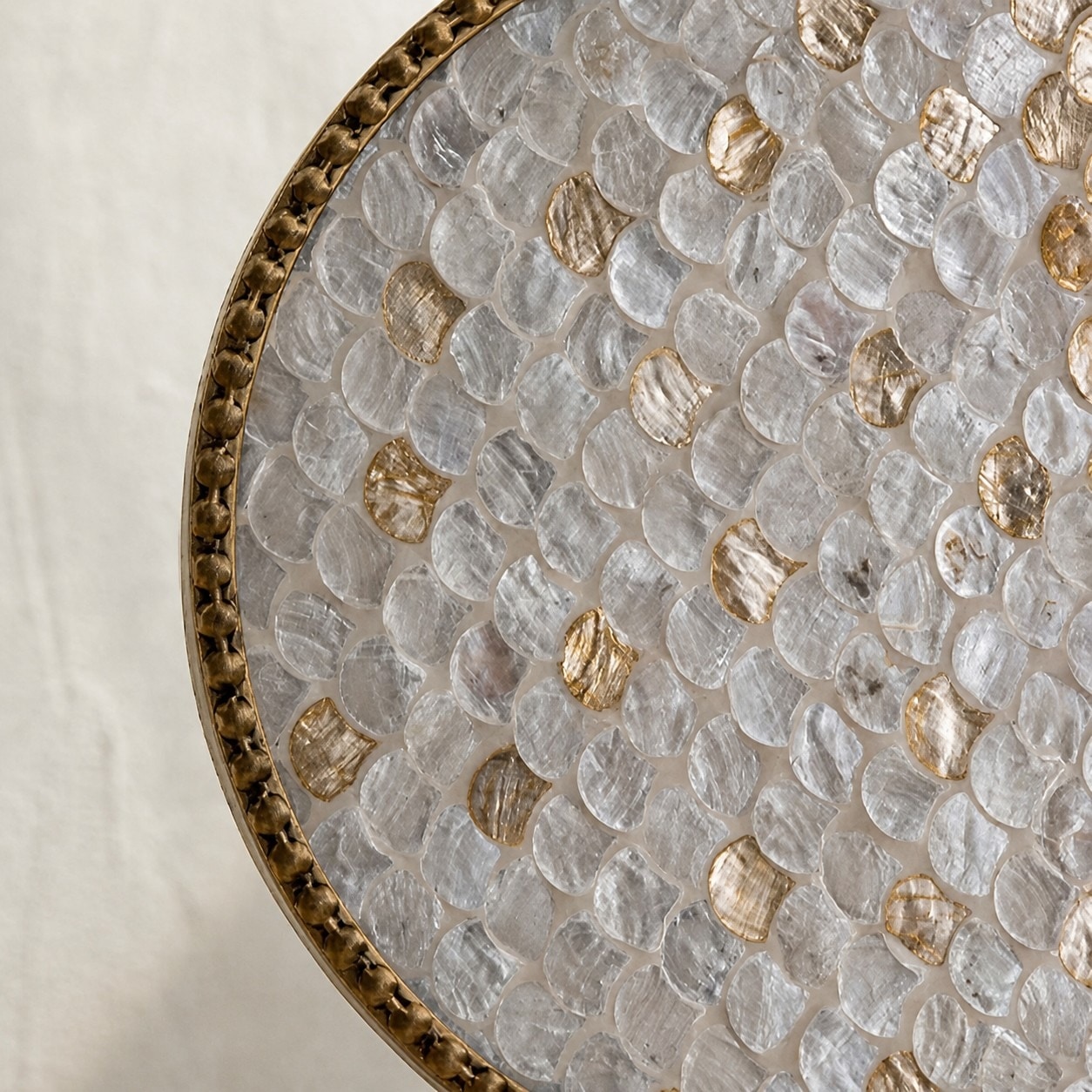 Close up of shell inlay surface with translucent gold-toned accents