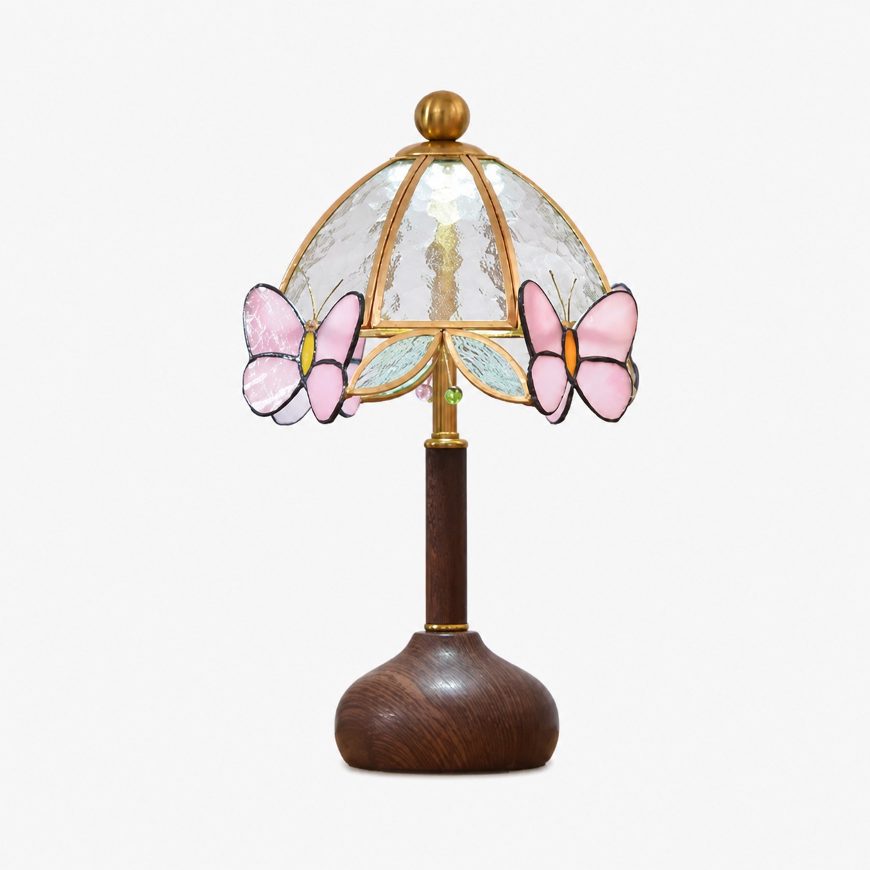Butterfly table lamp with pink stained glass butterflies, hammered glass shade, brass frame, and wood grain base